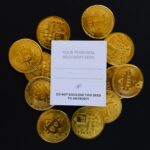 a pile of gold bitcoins sitting on top of a table